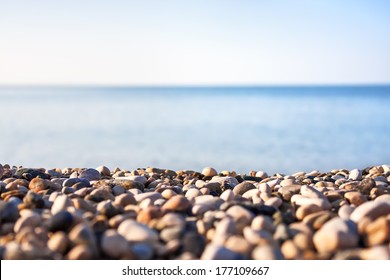 Pebble beach and blue sky on background