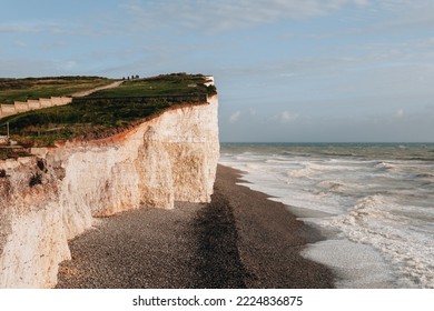 Pebble beach by Seven Sisters chalk cliffs, one of the longest stretches of undeveloped coastline on the south coast, East Sussex, UK.