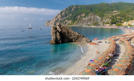 Pebble beach Monterosso vacation Cinque Terre Monterosso al Mare Chairs and umbrellas fill the Spiaggia di Fegina beach, Monterosso, part of the Cinque Terre Italy on a sunny day - Powered by Shutterstock