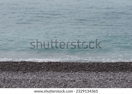 Pebble beach with nice clean sea waves