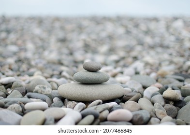 Pebble Round Stones For Meditation On Blurred Abstract Background. Rounded Pebble Stones For Meditation Laying On Seacoast. Spa Stones, Zen Like Concept. Pile Of Circle Stones High Quality Photo.