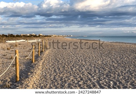 Pebble stone beach. Sea beach ocean shore. Coastline on empty pebble beach. Sea beach landscape. Coast pebbles. Shore landscape on Spain resort, Almarda. House on coastline. Waterfront vacation home