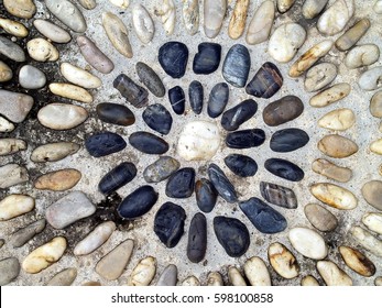 Pebble Stone Embedded In Concrete Floor, Smooth Cobblestones Arranged In Layered Circular Radial Pattern For Decorate Zen Spa Garden Walkways, Pathway For Foot Reflexology Massage, Close-up Top View