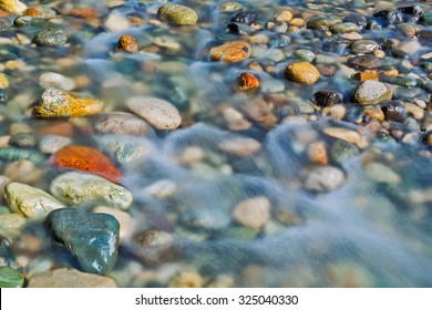 Pebble Stones In The River Water Close Up View,