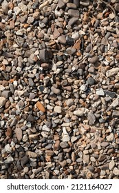 Pebble texture. The surface of the earth with small multi-colored stones. Natural background. Ground texture.