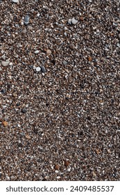 pebble texture. vertical texture of small pebbles. pebbles on the beach