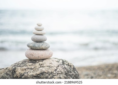 Pebble tower balance harmony stones arrangement on sea beach coastline. Relaxing peaceful formation pyramid cobblestone philosophy equilibrium spiritual tranquility. Spa therapy summer travel vacation - Shutterstock ID 2188969525