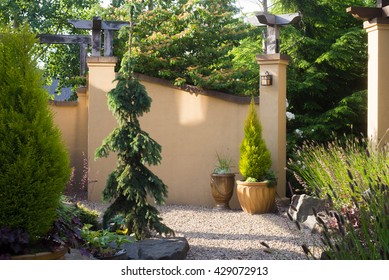 A Pebbled Walkway At The Entrance To A Backyard Retreat Filled With Perennials  Inspired By Tuscany.