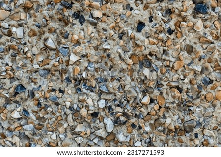 Pebbledash a course plaster texture of small stones and cement covering the wall of a house