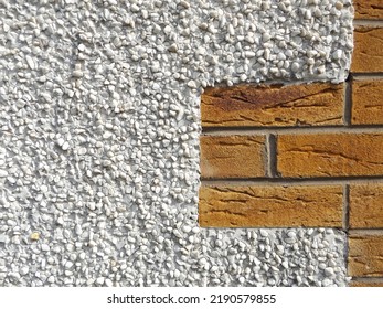 Pebble-dash wall with red brick - Shutterstock ID 2190579855