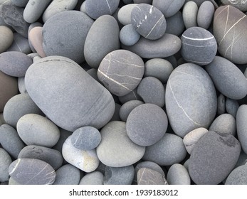 Pebbles background, abstract background with round gray stones,

