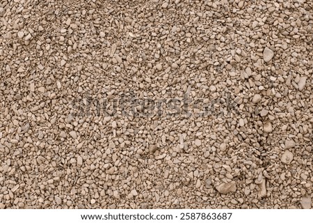 Pebbles background. Top view of river stones shingle , mineral material for pathways in modern urban garden or construction site