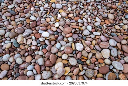 Pebbles On A Isolated Beach, Multicoloured And Textured. Thought Provoking, Calming And Peaceful.