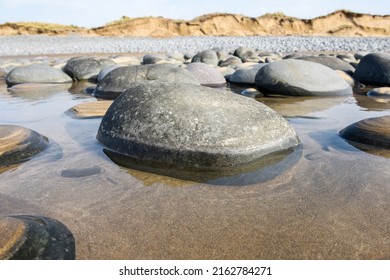 Pebbles In Rock Pools At The Beach Formed At Low Tide