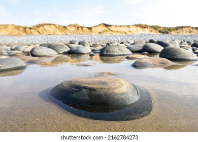 Pebbles In Rock Pools At The Beach Formed At Low Tide