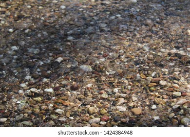 Pebbles in a stream in the sun
