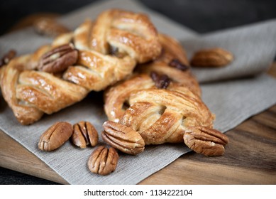 Pecan Danish Pastry On Napkin And Blur Wooden Board