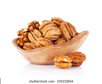Pecan nuts in bowl. Isolated on white background