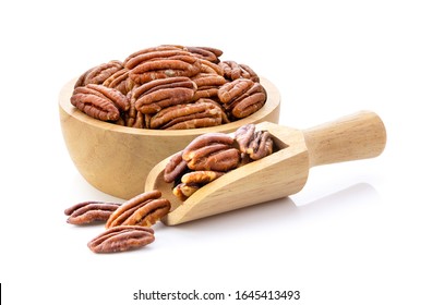 Pecan nuts topped with light salt in wood scoop and bowl  isolated  on white background