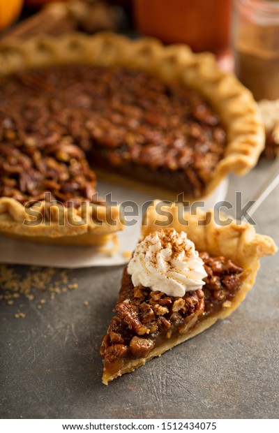 Pecan pie\
topped with whipped cream for\
Thanksgiving