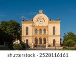 Pecs Synagogue in Hungary. The face of the synagogue is decorated with a clock and an inscription in Hebrew that reads, "For my house, be called to the house of prayer for all peoples." 