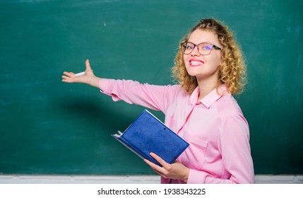 Pedagogue hold book and explaining information. Teacher explain hard topic. Woman school teacher in front of chalkboard. Teacher best friend of learners. Passionate about knowledge. Education concept