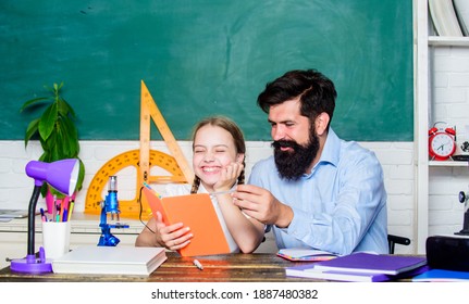 Pedagogue skills. Talented pedagogue. Work together to accomplish more. Fascinating lesson. Explaining science to child. School teacher and schoolgirl. Man bearded teacher excellent pedagogue.