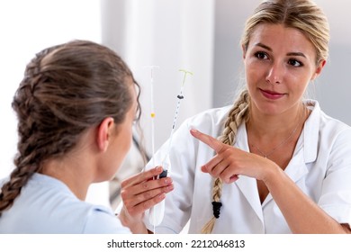 Pedagogy-IUD in close-up held by the doctor to explain its principle of foctioning. - Shutterstock ID 2212046813