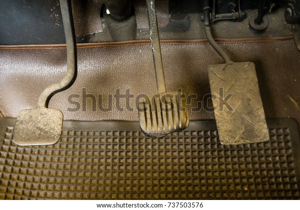 Pedal\
accelerator ,brake and  car clutch in the old\
car