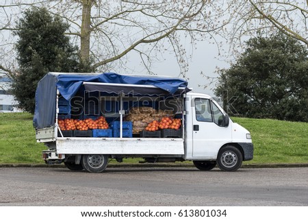 Peddler with a van full of fruit.