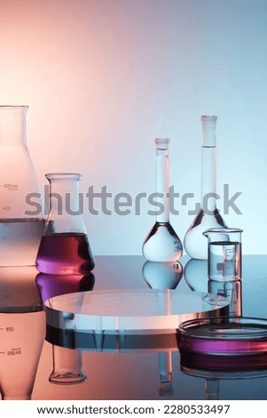 Pedestal for product display presentation with transparent podium, lab glassware containing purple liquid on purple gradient background. Lab theme. Science and medical background