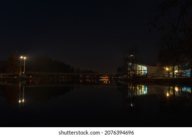 Pedestrain foothpath in city Ceske Budejovice with bridge on river Vltava at night. Long exposure city