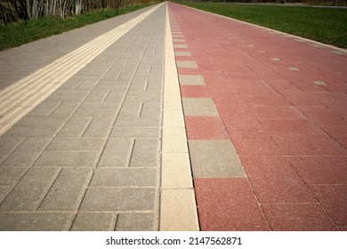 Pedestrian And Bike Paths Converge On The Horizon. Perspective. A Special Relief Strip On The Pavement For Blind People.