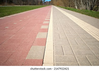 Pedestrian And Bike Paths Converge On The Horizon. Perspective. A Special Relief Strip On The Pavement For Blind People.