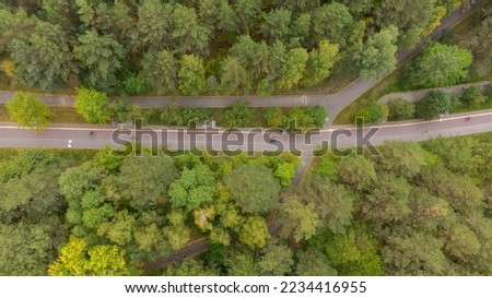 Pedestrian and bike paths in the park from a height. Top view of the pedestrian zones in the park. Modern city park. Photographs of the city of Novosibirsk from a height, aerial photography, Russia, 