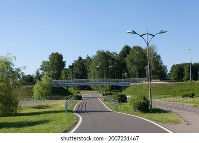 Pedestrian Bridge Over The Bike Path In The Summer Park. There Are No People In The Deserted Park.