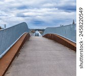 Kâhasinîskâk Pedestrian Bridge over Connors road edmonto with prospective view to the pyramid of Muttart Conservatory