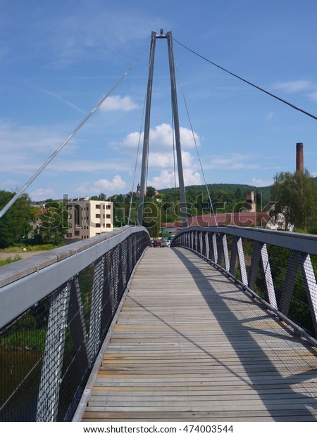 a pedestrian\
bridge suspended on iron\
ropes