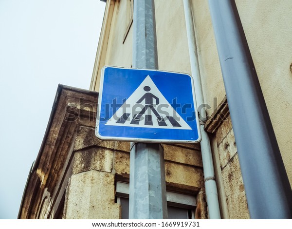 Pedestrian Crossing blue\
sign in the street