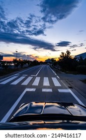 Pedestrian Crossing In The Evening, Seen From Oncoming Car	