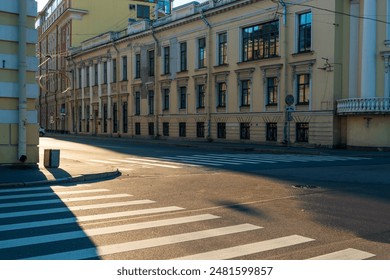 Pedestrian crossing on an empty street flooded with sunlight in an old European city - Powered by Shutterstock