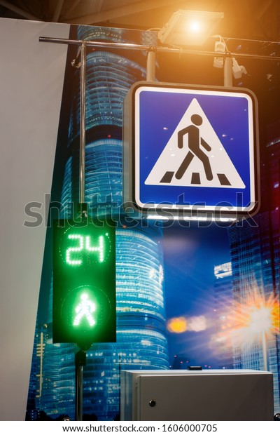 Pedestrian crossing street sign and traffic\
light for\
pedestrians