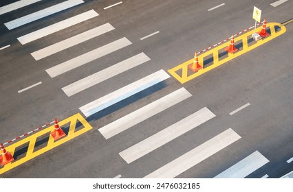 Pedestrian crossing with white marking lines on asphalt road aerial top view background. - Powered by Shutterstock