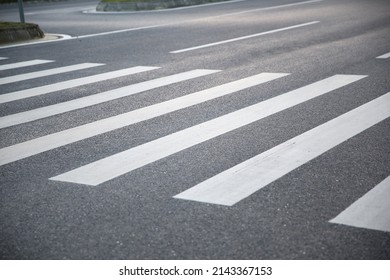 pedestrian crossing, white stripes on black asphalt, road markings zebra crossing, place to cross the road, traffic rules - Powered by Shutterstock