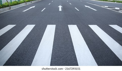 pedestrian crossing, white stripes on black asphalt, road markings zebra crossing, place to cross the road, traffic rules - Powered by Shutterstock