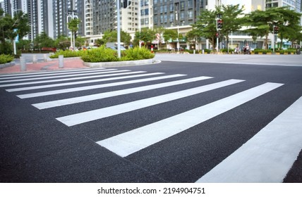 pedestrian crossing, white stripes on black asphalt, road markings zebra crossing, place to cross the road, traffic rules - Shutterstock ID 2194904751