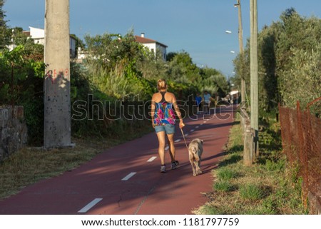 Similar – Happy young people walking along road in summer day