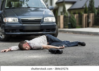 Pedestrian Hit By A Car Lying On The Street