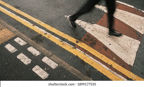 Pedestrian Or Jogger On Road Speed Bump With White Arrows And Red Surface, Near No Parking Double Yellow Lines. Manchester, England, UK.