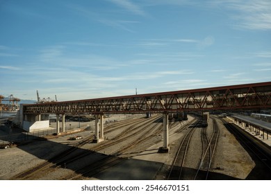 a pedestrian overpass above the railway tracks of a major station - Powered by Shutterstock